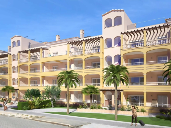Pastel yellow multi-story apartment building with arched balconies and palm trees in front under a clear blue sky, on a sunny day.