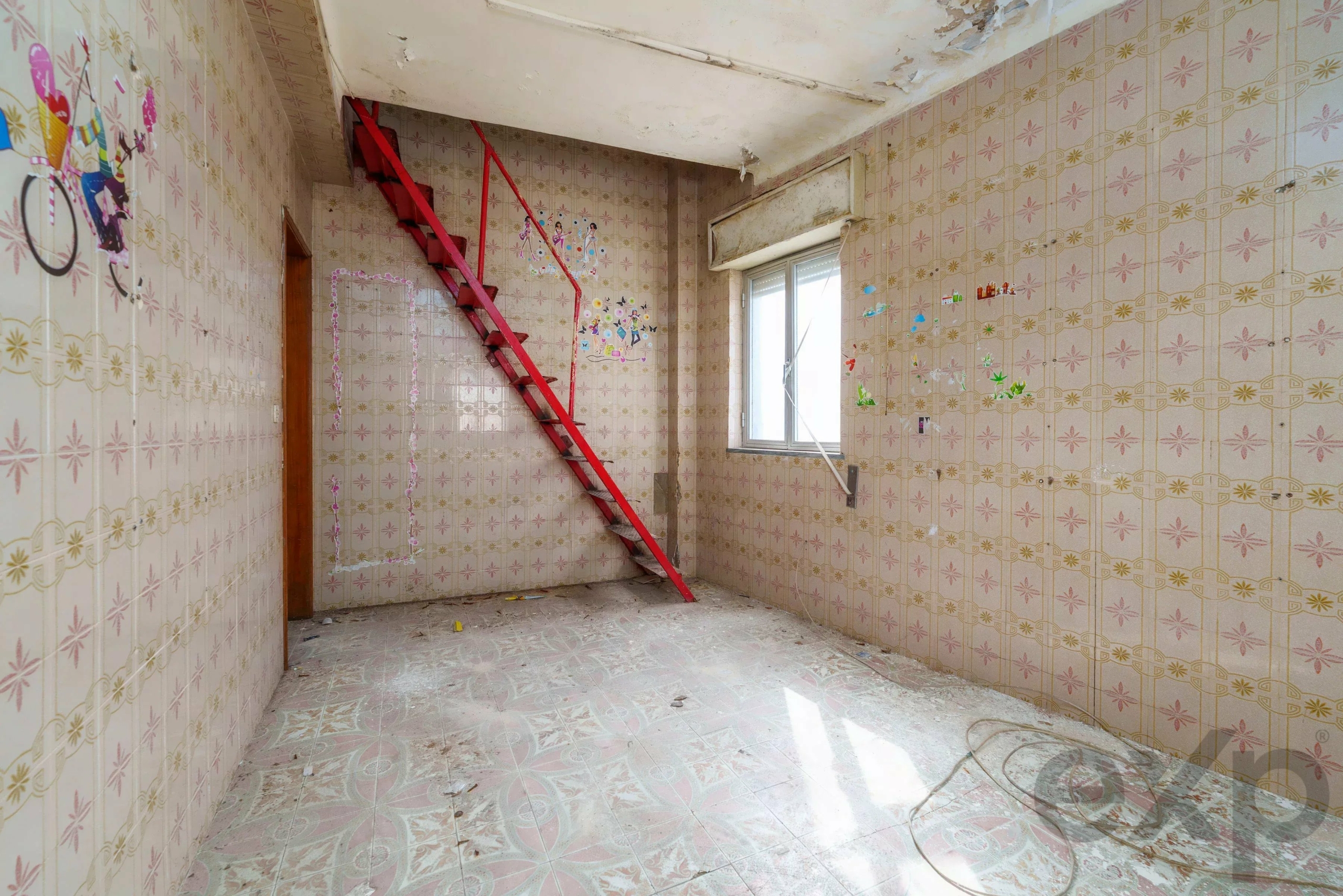 Abandoned pink-tiled room with a red metal ladder leaning diagonally, peeling ceiling, and colorful wall decals.