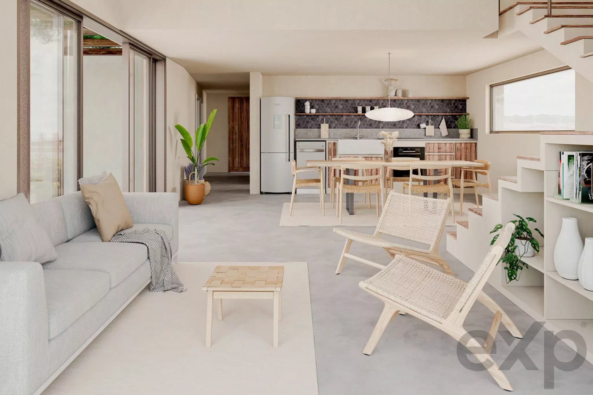 Open-plan living area with a gray sofa, light wood dining table, and a modern kitchen featuring a black tile backsplash and open shelves along the back wall.