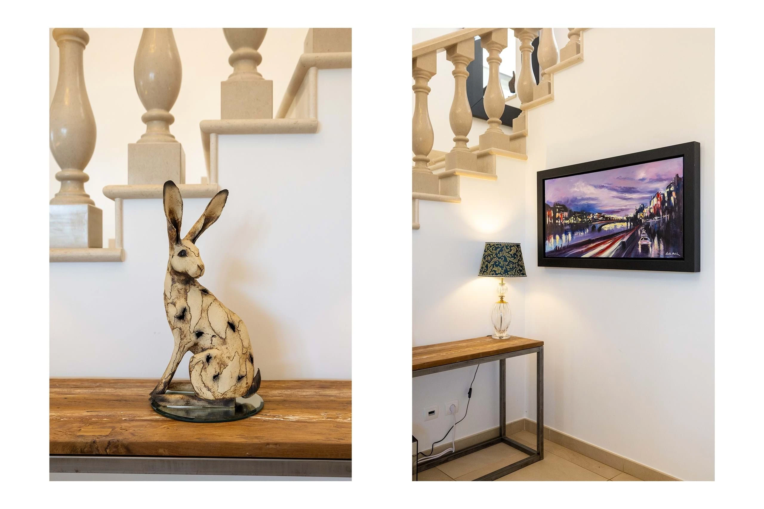 T5 Villa with pool in Ferrel 5mn from beach and Lagos centre – SunnySteve 28 Two interior photos: left shows a carved rabbit sculpture on a wooden table with a beige staircase railing; right shows a framed cityscape painting above a console table with a lamp on the wall.