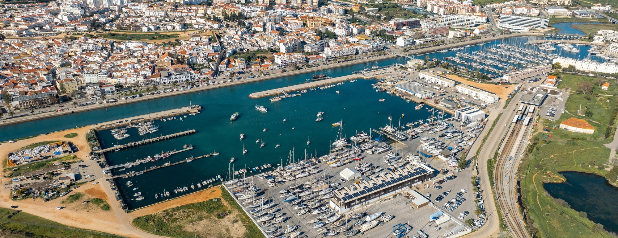 Aerial drone view of Lagos Marina in the Algarve, Portugal, showing the boat marina, river and town, the area where non-resident Americans buy with a Portuguese mortgage
