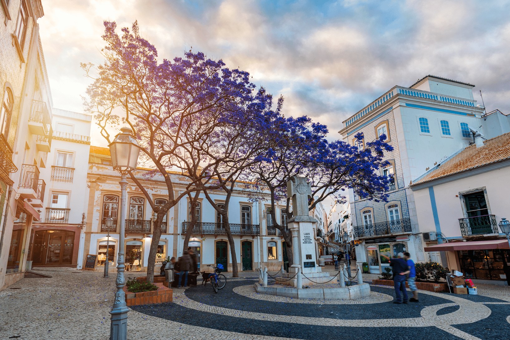 Praca Luis de Camoes in Lagos old town, Algarve, with jacaranda trees in bloom over the calcada pavement