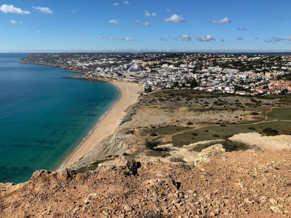 Praia da Luz and its bay seen from the Rocha Negra cliff, Western Algarve, where buyers look for off-market villas and pocket listings