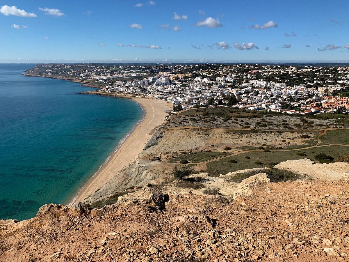 Praia da Luz and its bay seen from the Rocha Negra cliff, Western Algarve, where buyers look for off-market villas and pocket listings