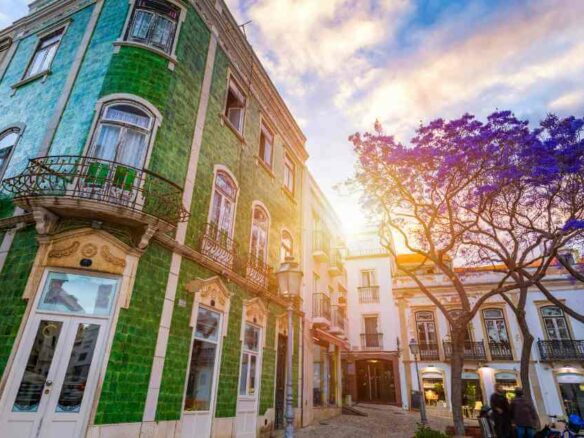 Tiled townhouses and jacaranda trees in Lagos old town, Algarve, where foreign buyers are asking whether Portugal will restrict property purchases in 2026